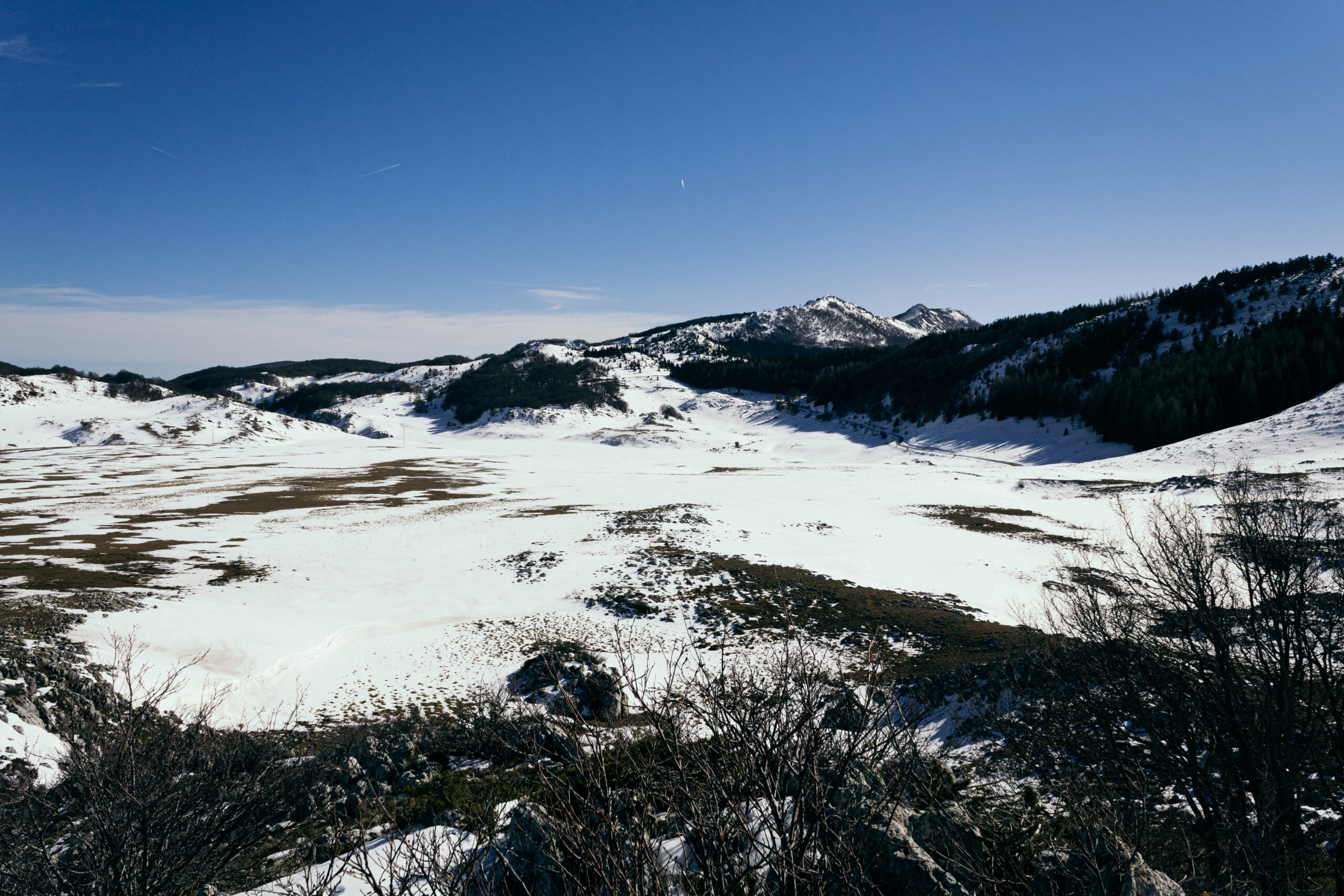 Landscape photograph of a snow covered plateau and mountains, in the centre of Italy.