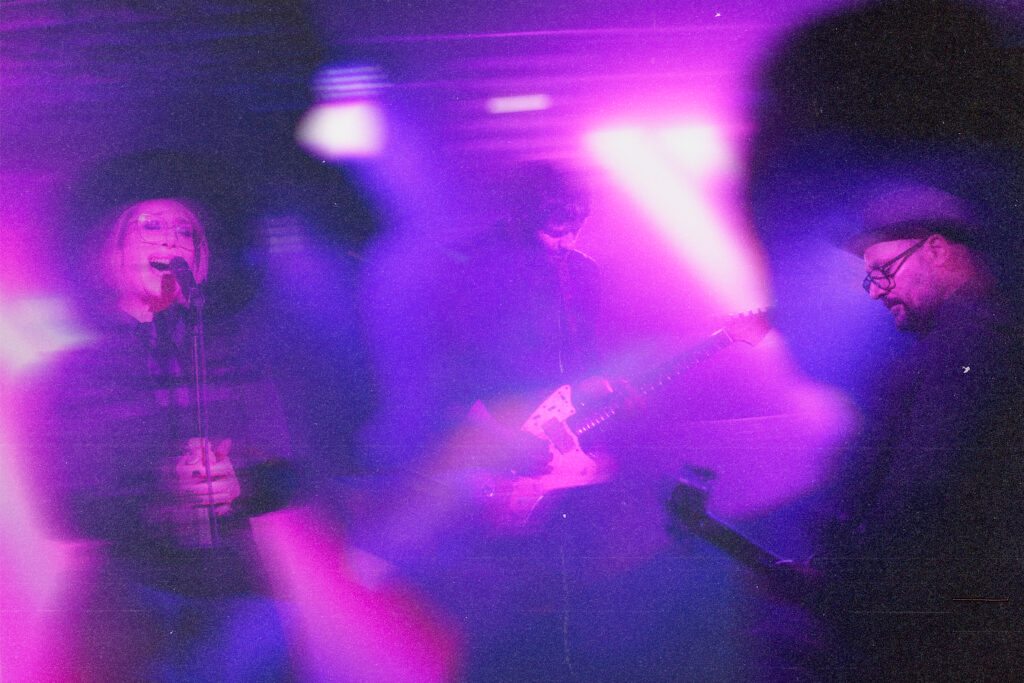 Purple collage of pictures of the band Sorry, Heels performing live.
