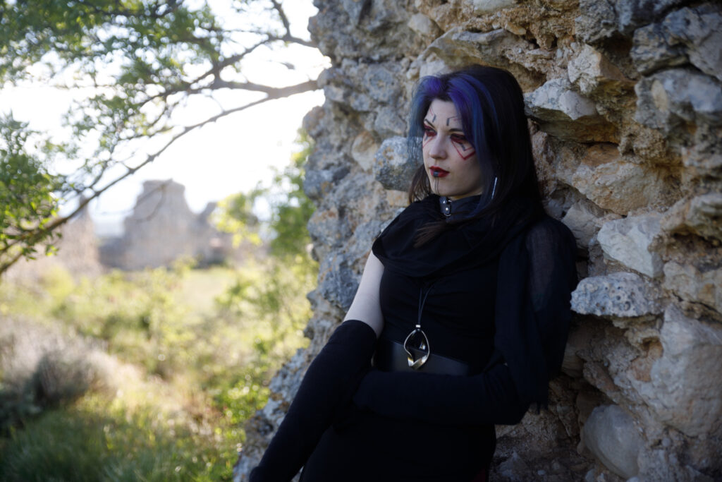 Sith portrait from my Star Wars editorial. It's a woman, with dark makeup and clothing, leaning against the wall of some ruins. Unedited.