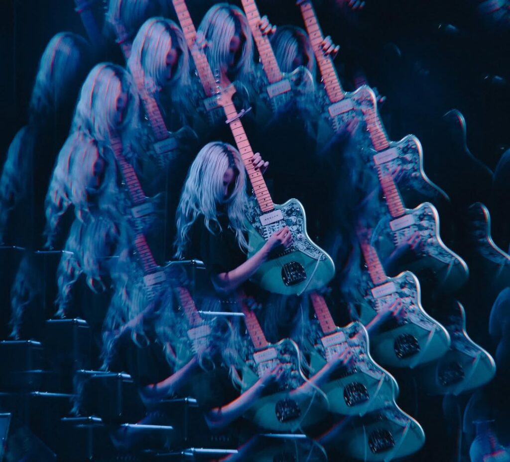 The guitar player from Softcult performing live, shot with a Kaleidoscope filter